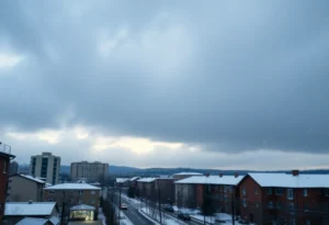 A winter scene of Charlotte with dark clouds and snow, illustrating an approaching cold front.