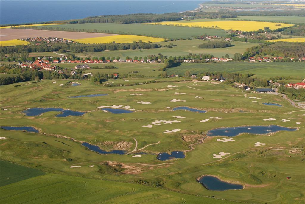 Golf course fairway under clear sky