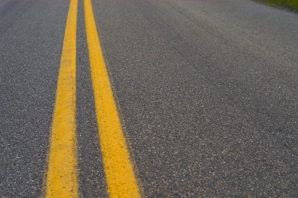 Empty roadway with painted center line stretching ahead